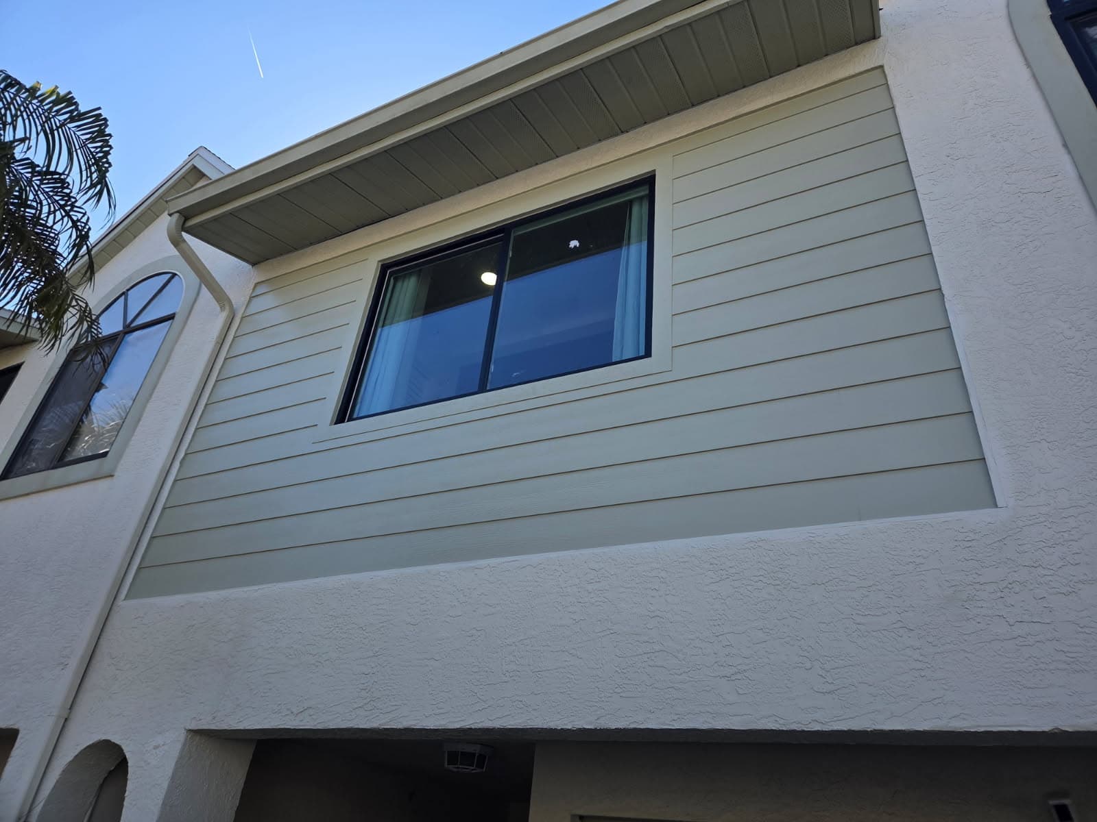KJB Construction exterior siding and window installation on two-story stucco home