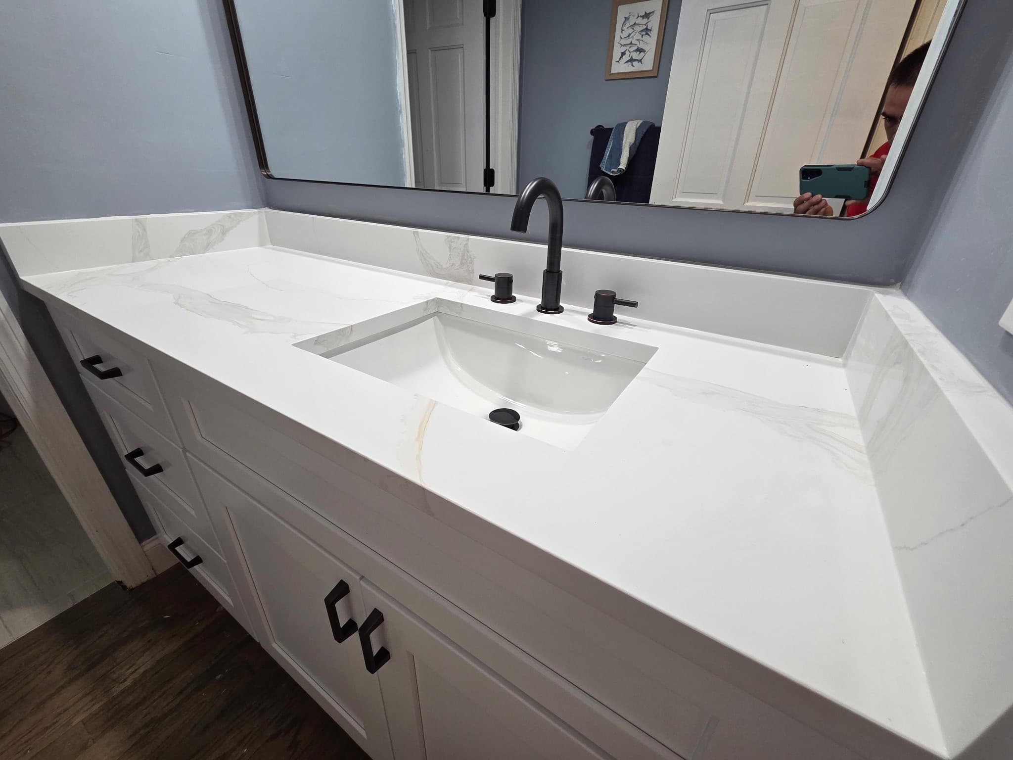 KJB Construction white quartz vanity countertop with matte black faucet and hardware