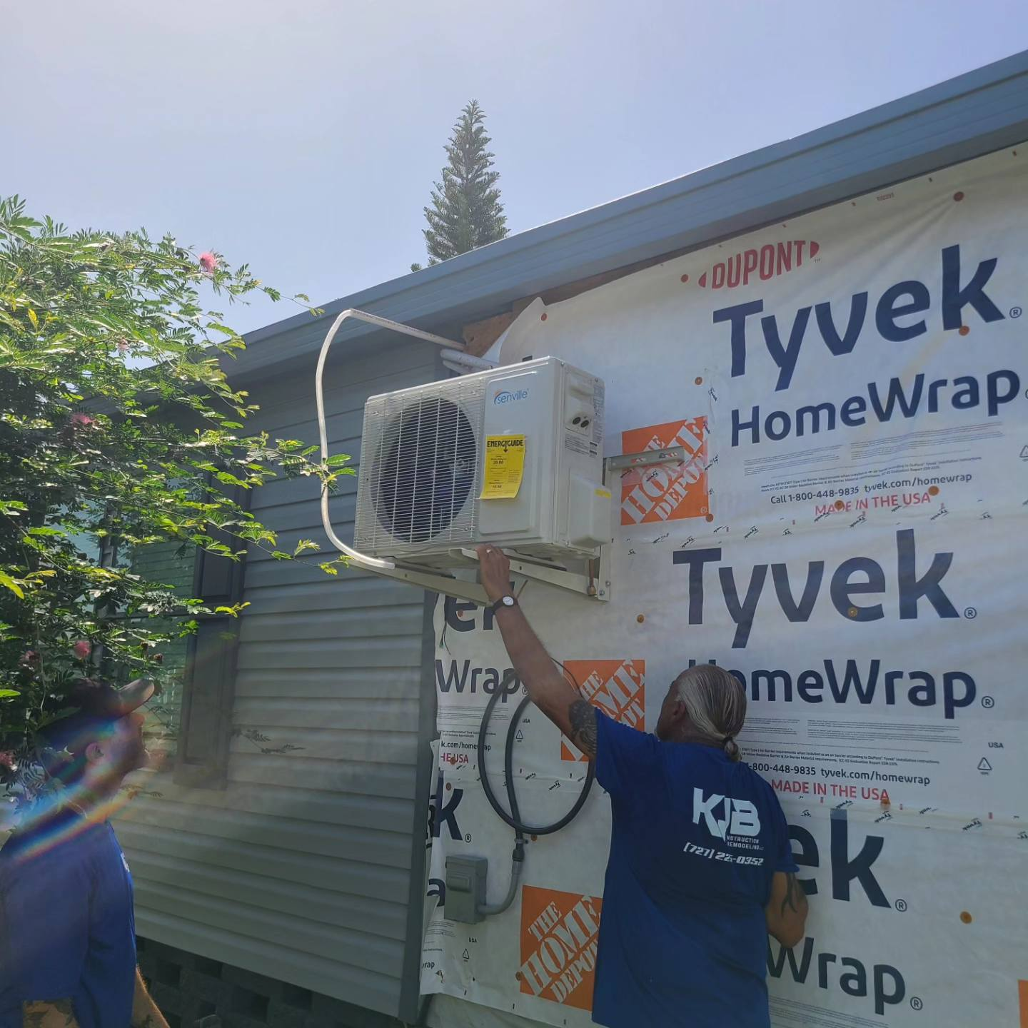 AC unit installation on house exterior with Tyvek HomeWrap