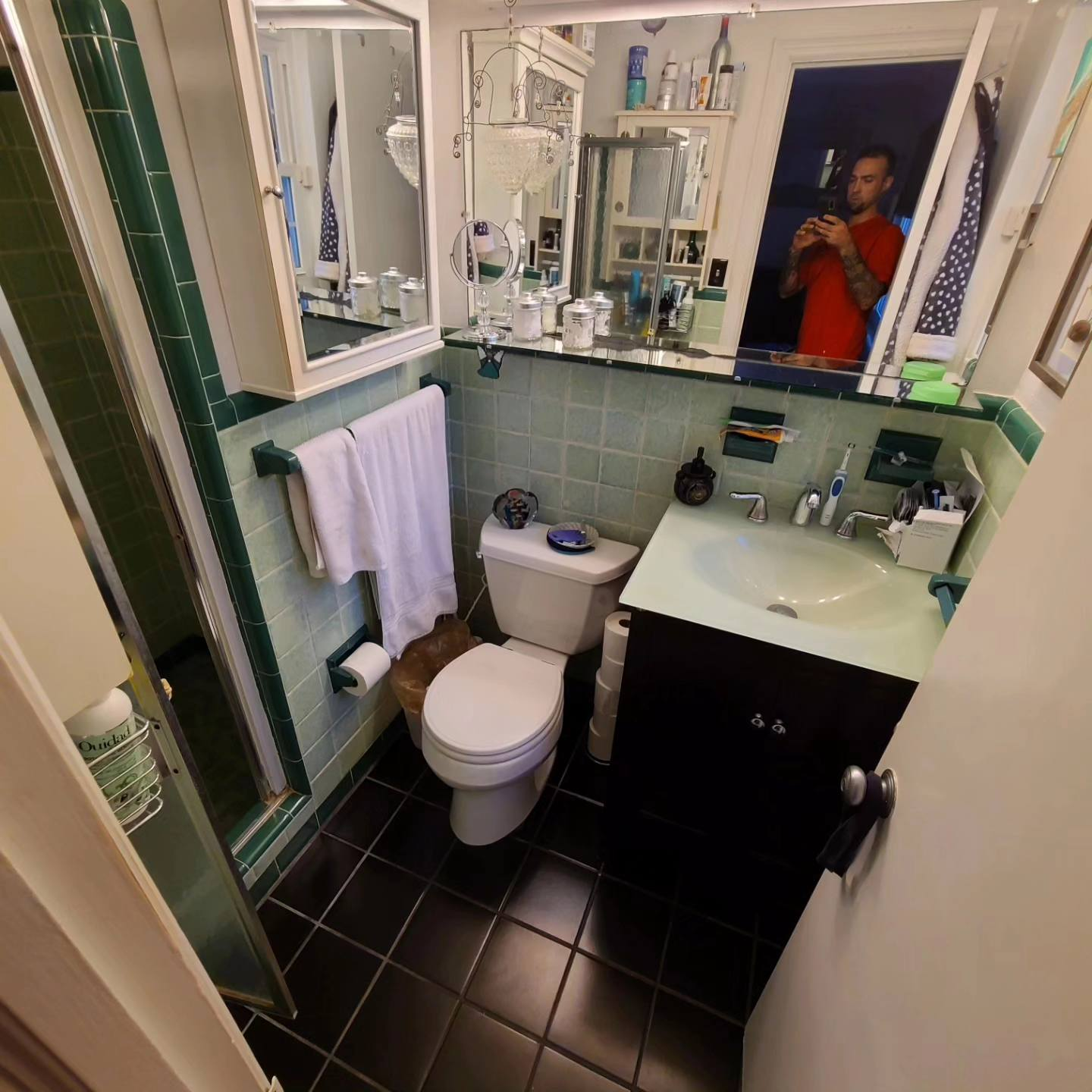 Finished bathroom with green tile, black vanity, and modern fixtures