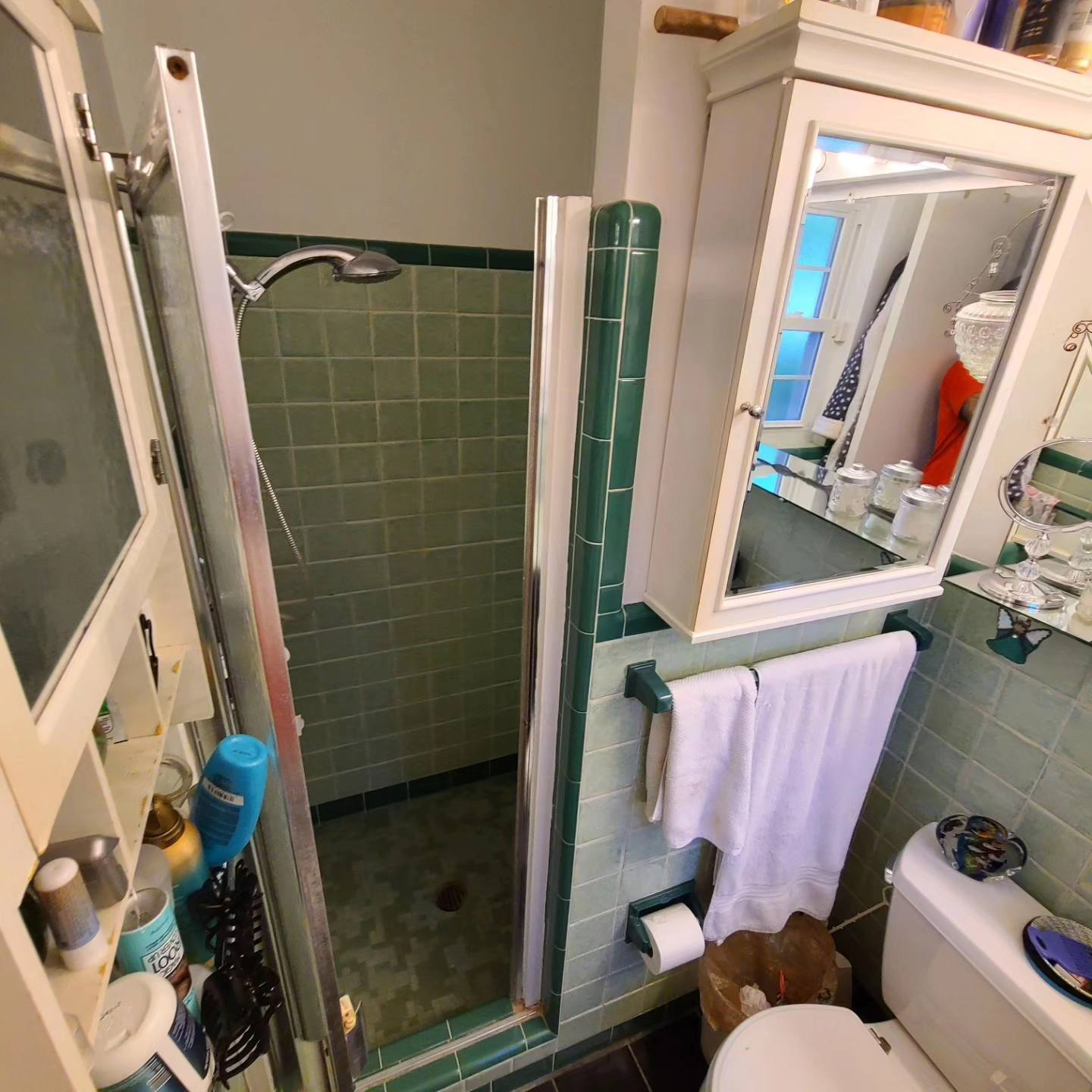 Finished bathroom with green tile shower and white fixtures